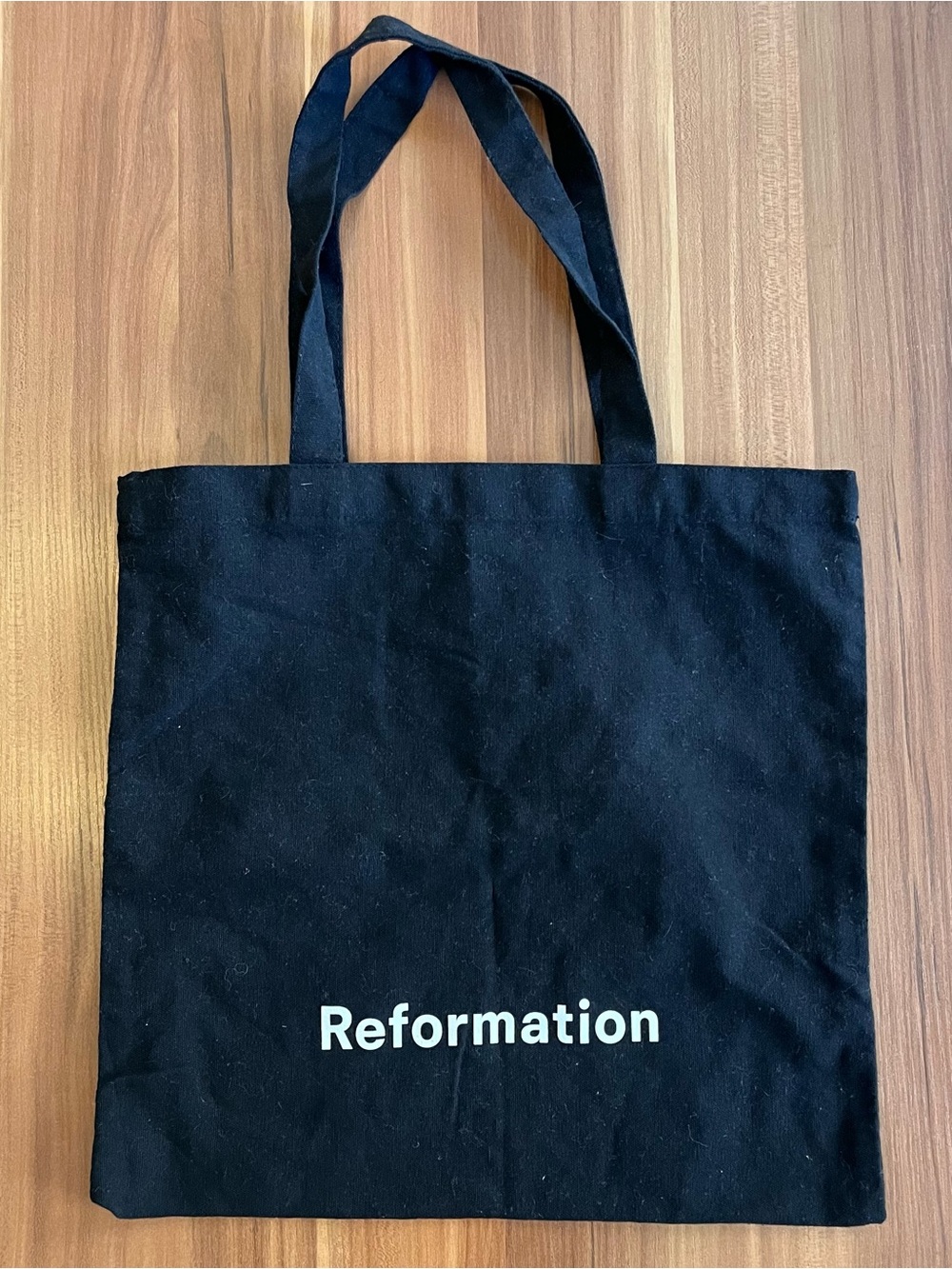 Reformation black canvas tote with white logo